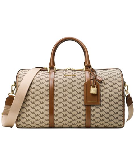 michael kors duffle bag with webbing|Michael Kors trolley suitcase.